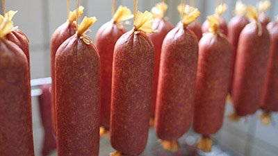 Frisch hergestellte Wurstspezialit&auml;ten zum Reifen aufgeh&auml;ngt